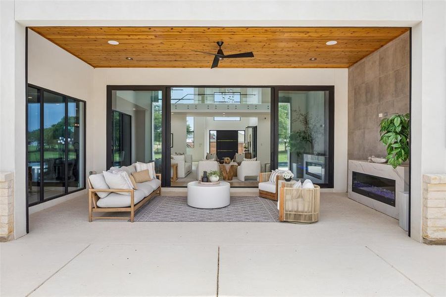 Indoor outdoor living with large slider doors opening to the patio with motarized screens.