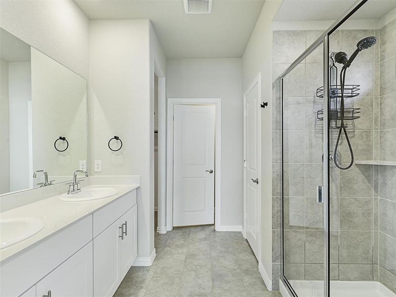 Bathroom with vanity and a shower with shower door