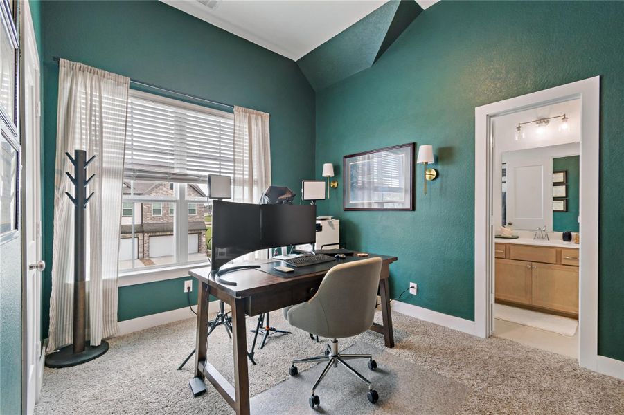 Bright and inviting home office with large windows, modern furnishings, and an adjacent bathroom for convenience. Bright and inviting home office with large windows, modern furnishings, and an adjacent bathroom for convenience.