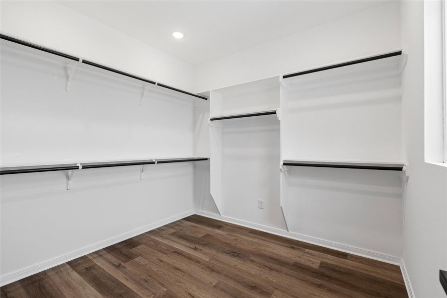 Spacious walk-in closet with ample shelving and hanging space for effortless organization.