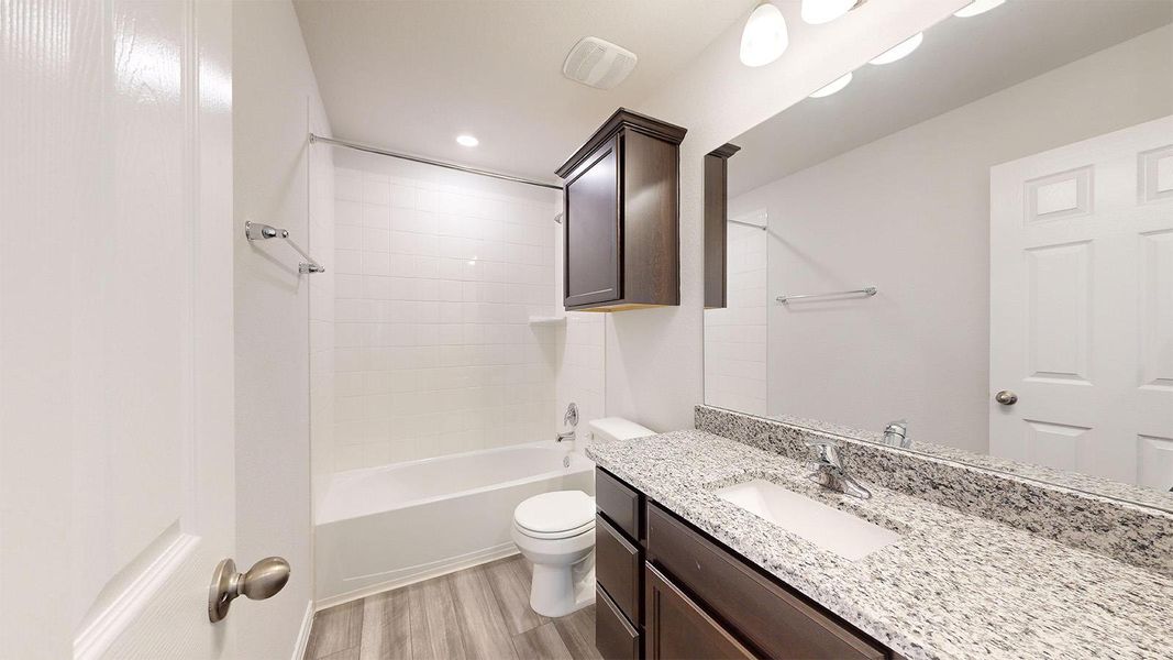 Full bath with vanity, shower / bath combination, light wood-type flooring, and recessed lighting