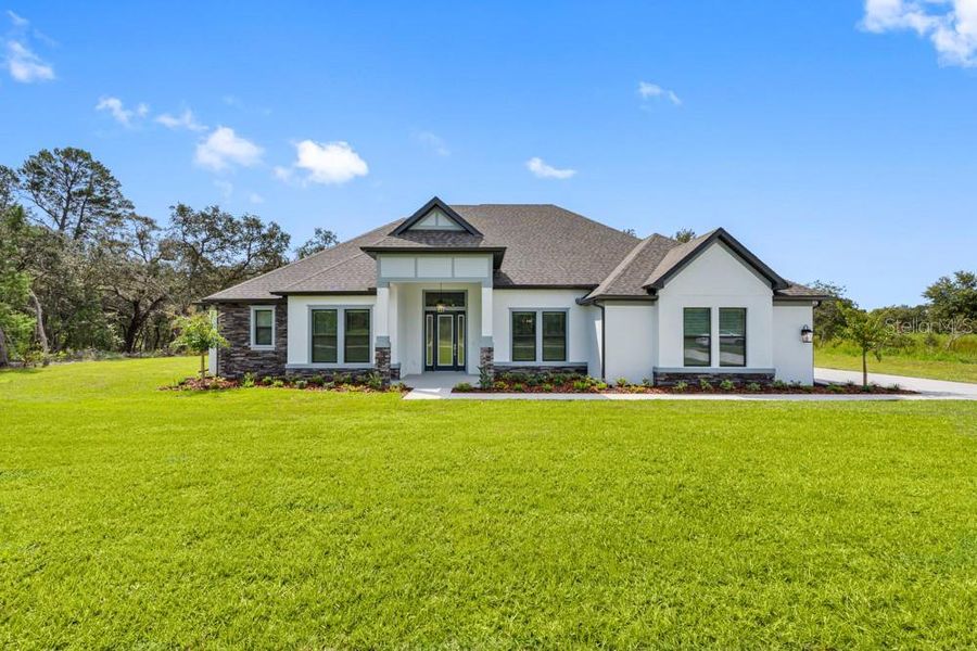 Front exterior of a new home in , Hudson, FL, highlighting curb appeal (Image 1). Front exterior of a new home in , Hudson, FL, highlighting curb appeal (Image 1).