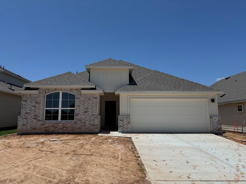 View of front facade with a garage, driveway, roof with shingles, and brick siding View of front facade with a garage, driveway, roof with shingles, and brick siding