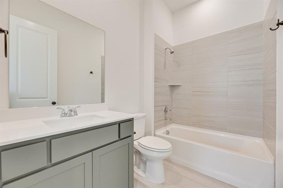Bathroom featuring washtub / shower combination and vanity Bathroom featuring washtub / shower combination and vanity