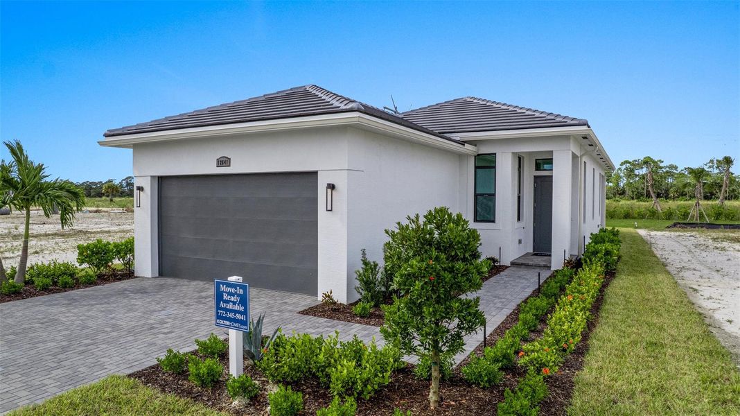 Front exterior of a new home in PGA Village Verano, Port St. Lucie, FL, highlighting curb appeal (Image 2). Front exterior of a new home in PGA Village Verano, Port St. Lucie, FL, highlighting curb appeal (Image 2).