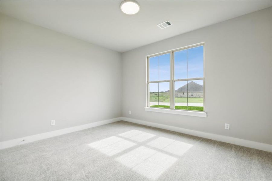 Empty room featuring light carpet