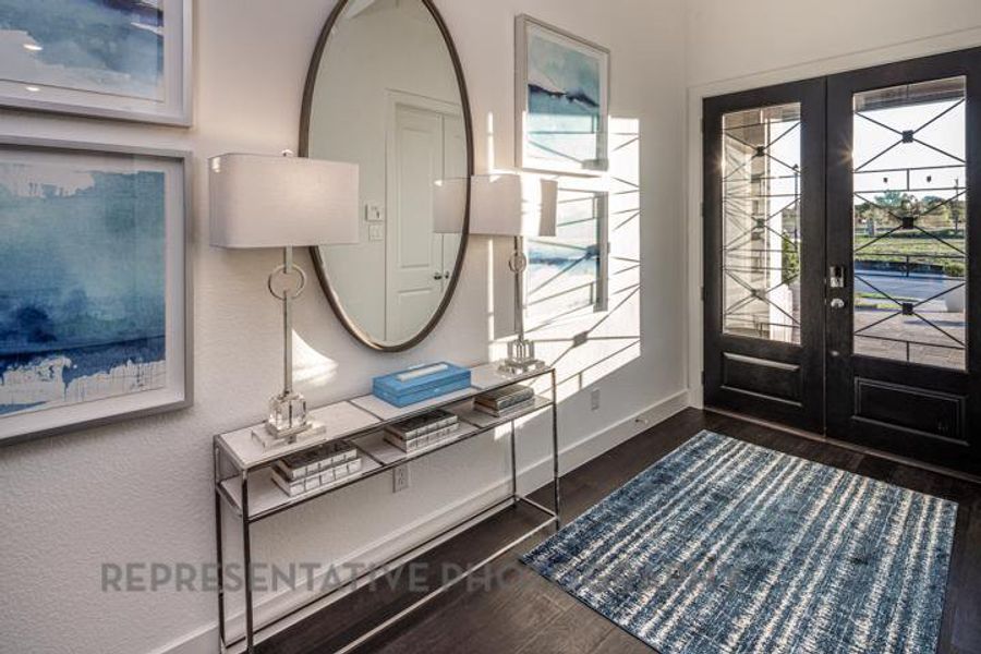 Entryway with french doors and dark wood finished floors Entryway with french doors and dark wood finished floors