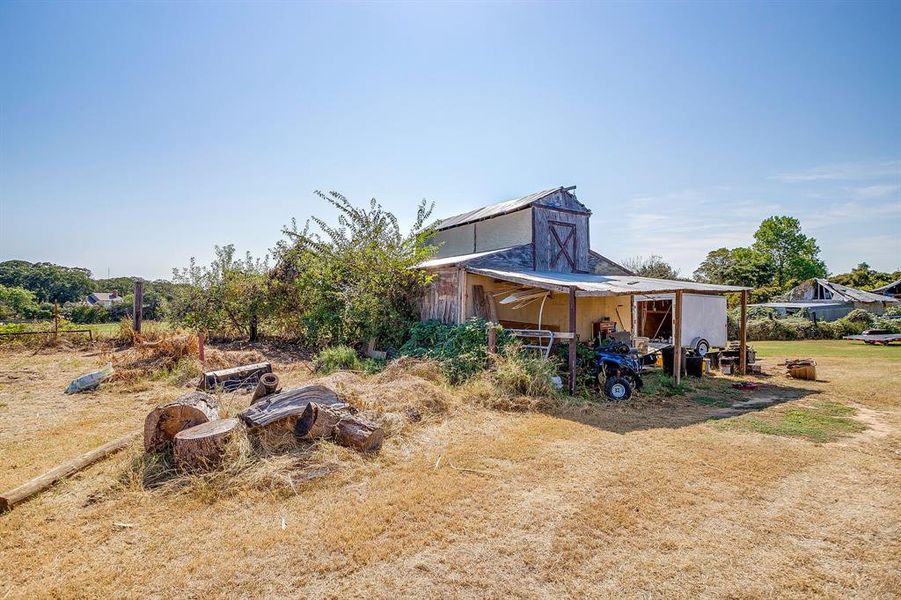 View of yard featuring an outbuilding and a barn View of yard featuring an outbuilding and a barn