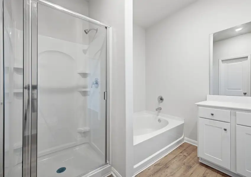 Primary bathroom with walk-in shower and garden tub in Montgomery floor plan