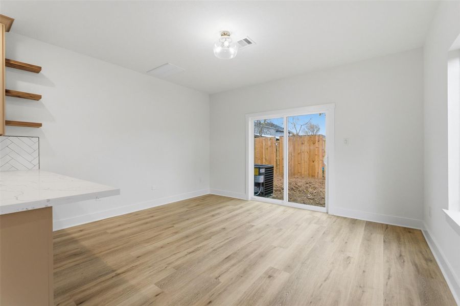 Large dining area with easy backyard access and plenty of natural light!