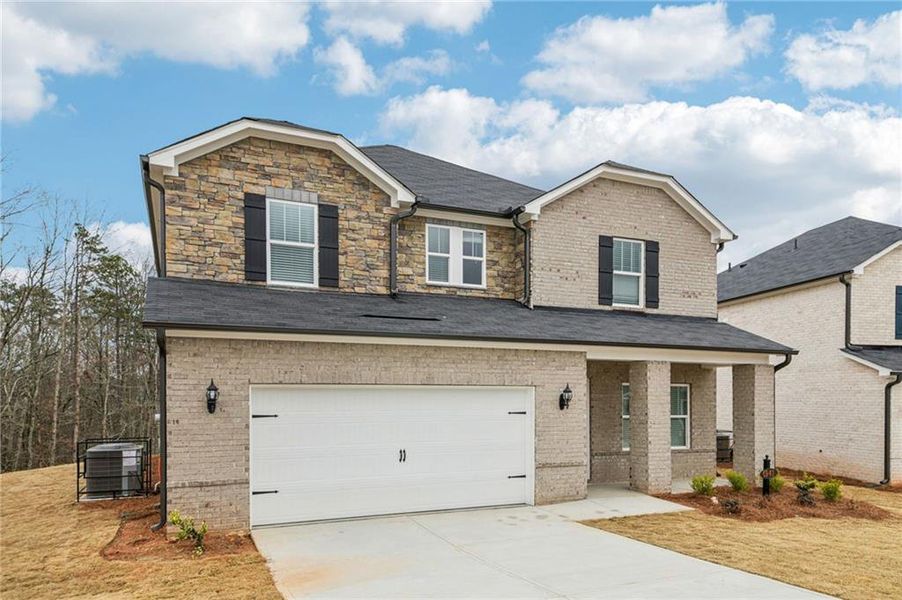 Front exterior of a new home in Creekside at Oxford Park, Fairburn, GA, highlighting curb appeal (Image 1). Front exterior of a new home in Creekside at Oxford Park, Fairburn, GA, highlighting curb appeal (Image 1).