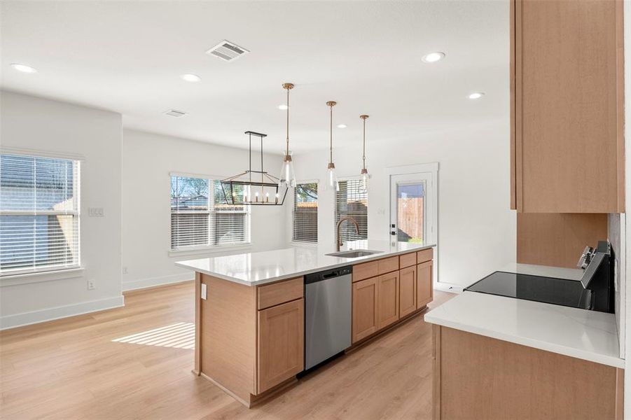 Kitchen featuring electric range oven, light wood-style flooring, stainless steel dishwasher, recessed lighting, and light stone counters
