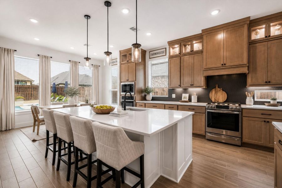 THIS KITCHEN IS A TRUE SHOWSTOPPER - DUAL TONED CABINETRY AND AN EXPANSIVE ISLAND CREATE THE IDEAL SETTING FOR HOME COOKED MEALS OR ENTERTAINING.