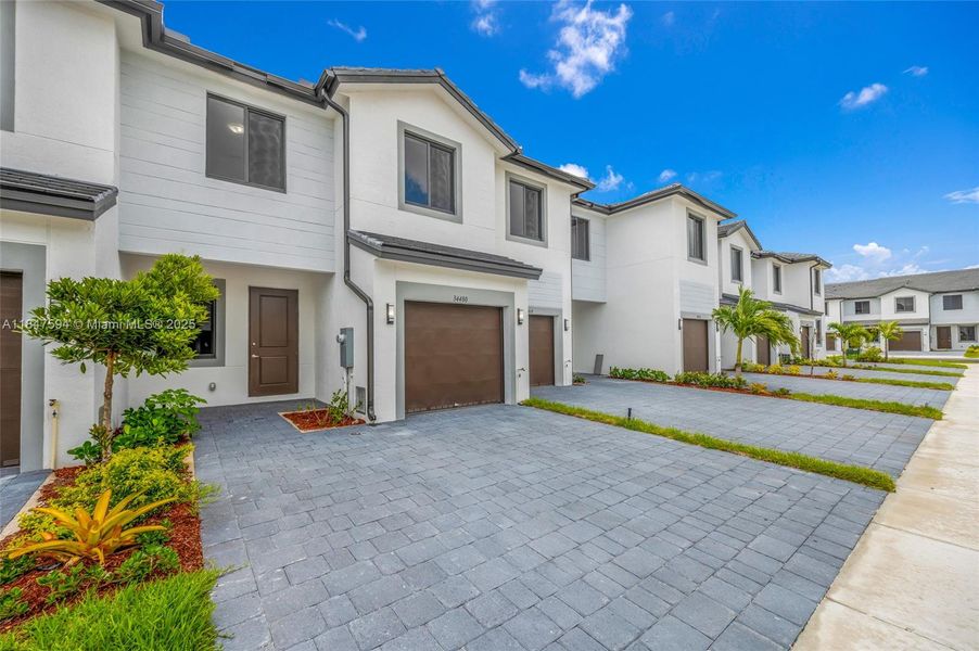 Front exterior of a new home in , Homestead, FL, highlighting curb appeal (Image 16).