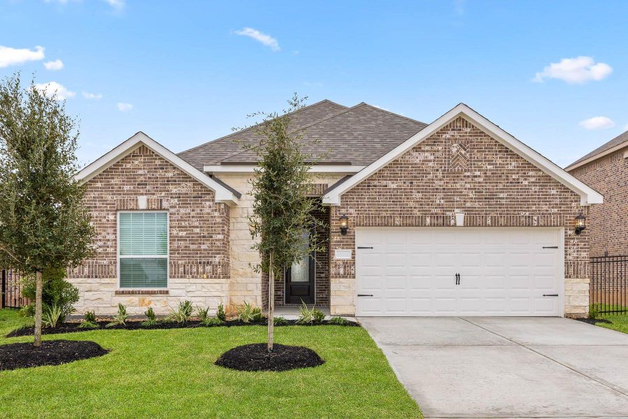 Front exterior of a new home in Sunterra, Katy, TX, highlighting curb appeal (Image 1).