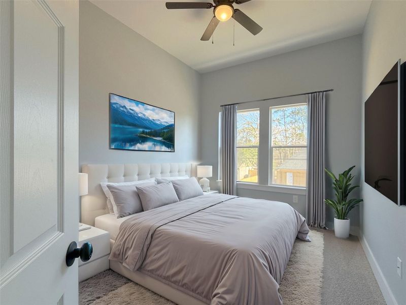 This spacious master suite is beautifully illuminated by abundant natural light through large windows.