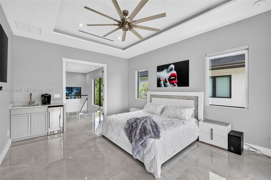 Primary bedroom suite w/ french doors, morning bar, en suite walk in closet and spa bathroom. Sliders lead to private balcony looking down the river