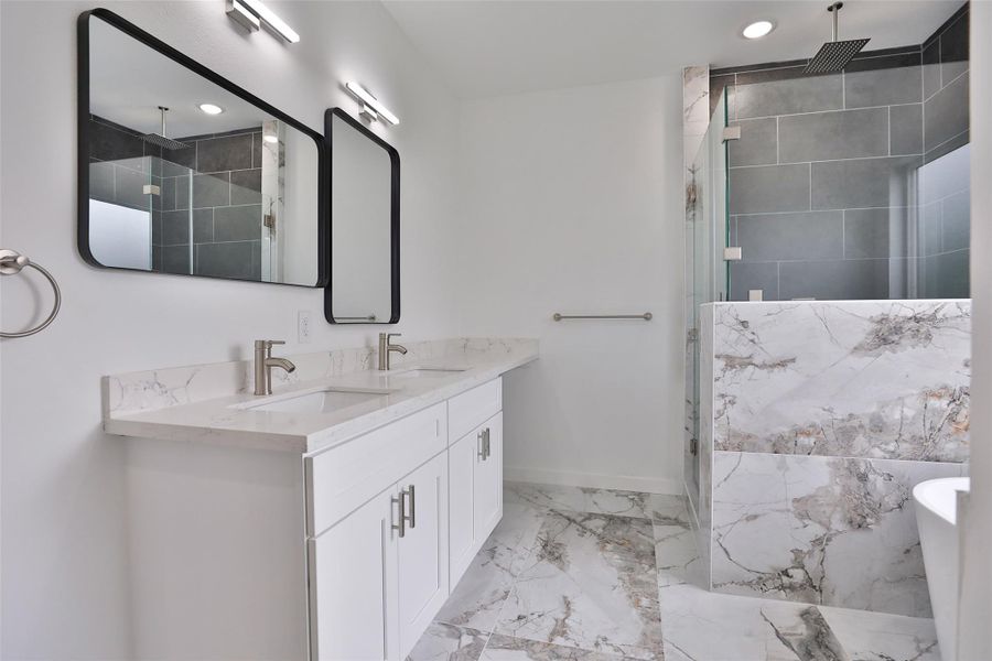Luxurious bathroom featuring elegant quartz countertops and exquisite European tile. Luxurious bathroom featuring elegant quartz countertops and exquisite European tile.