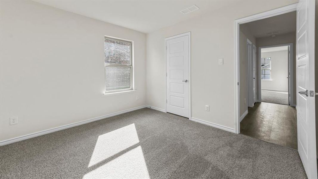 Room featuring light gray walls, gray carpeting, and a window with white trim