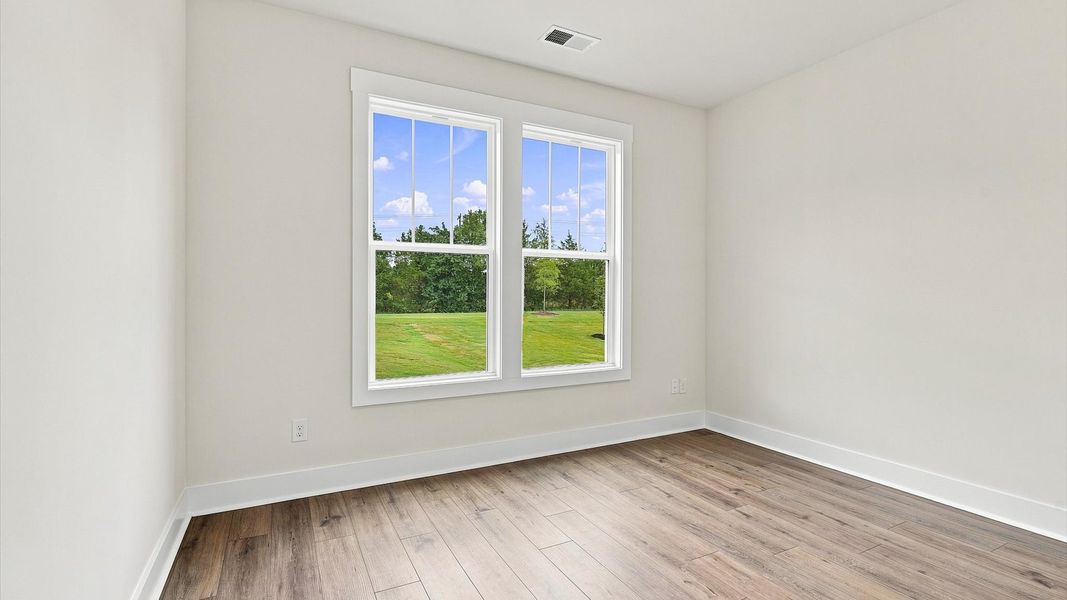 First-class bedroom with generous proportions, a walk-in closet, and beautiful natural light through large windows