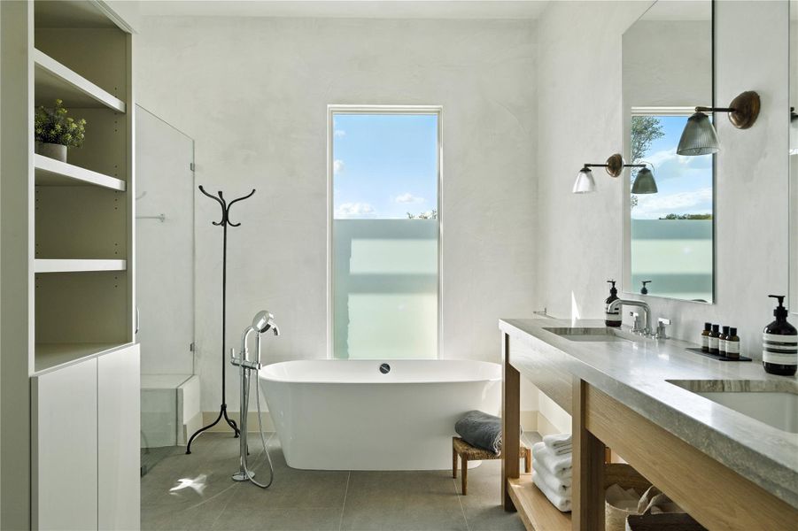 Full bath featuring a freestanding tub and double vanity