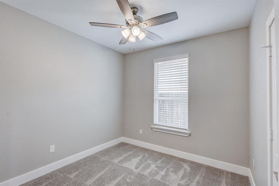 Spare room with carpet and ceiling fan