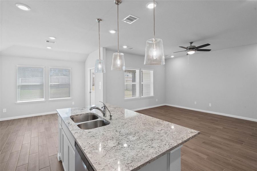 From the expansive kitchen island, enjoy seamless sightlines across the open-concept dining and living areas, making entertaining a breeze and ensuring you're never far from the conversation.