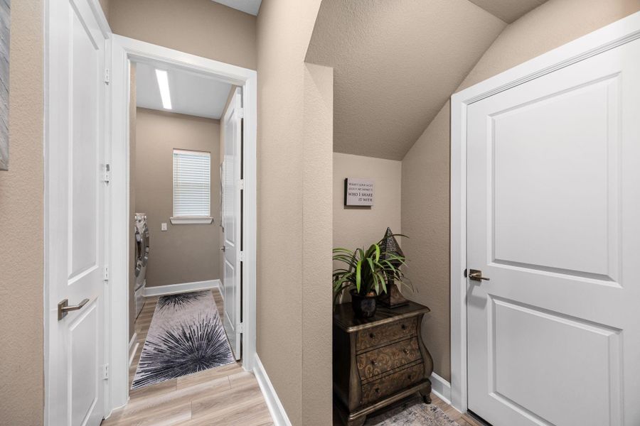 View from garage entrance with sight of half bath and large laundry room