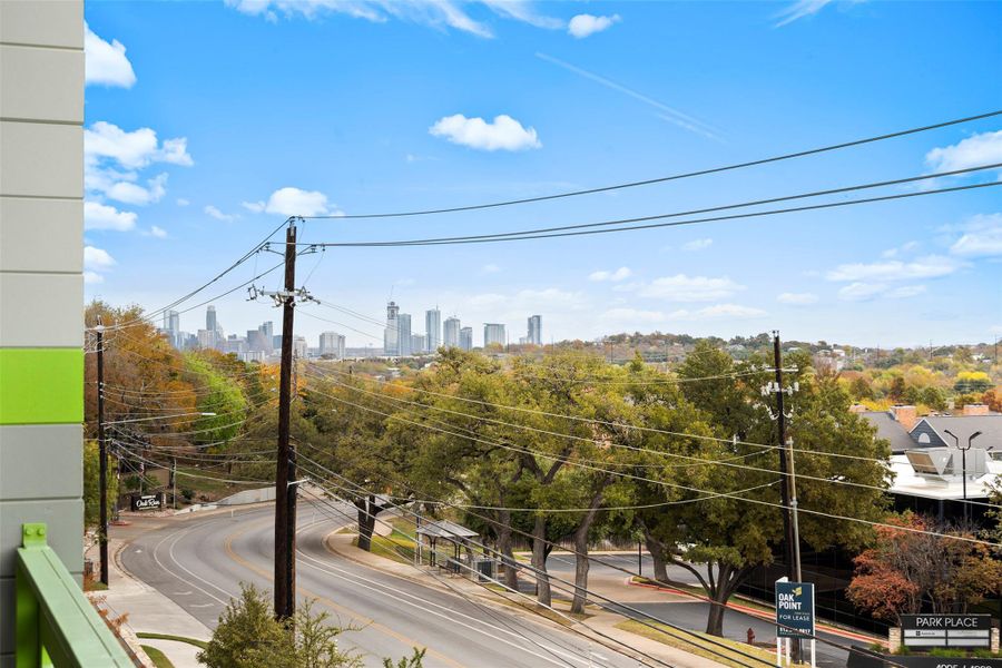 View of road featuring curbs, a view of city, and sidewalks