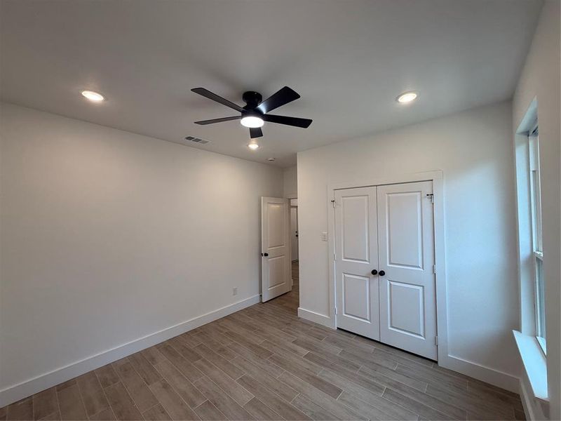 Unfurnished bedroom featuring recessed lighting, a ceiling fan, a closet, and light wood-style floors Unfurnished bedroom featuring recessed lighting, a ceiling fan, a closet, and light wood-style floors
