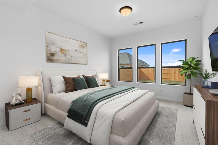 Serene primary suite with plush carpet and large windows—your perfect retreat to relax.