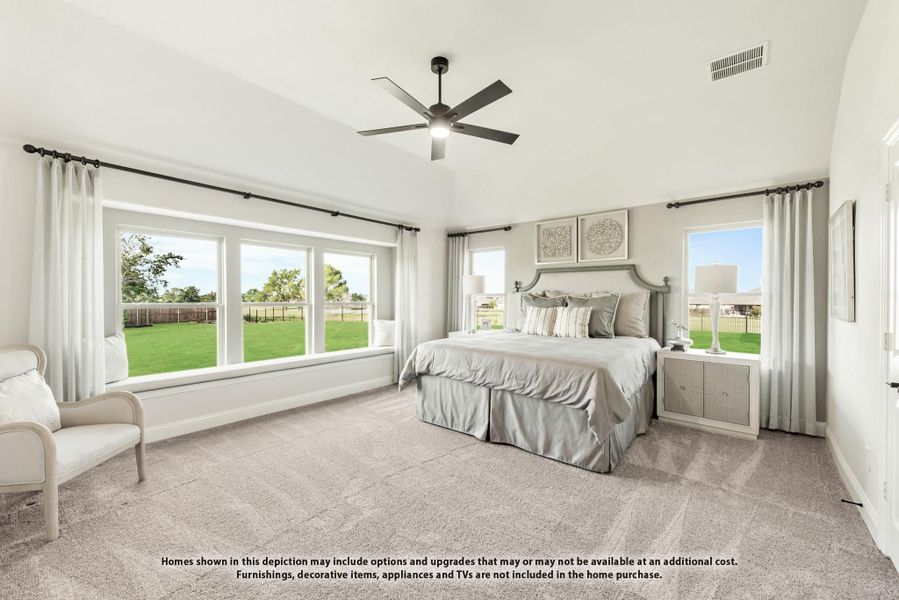 Spacious master bedroom with vaulted ceiling, ceiling fan, carpet flooring, and large windows overlooking a backyard Spacious master bedroom with vaulted ceiling, ceiling fan, carpet flooring, and large windows overlooking a backyard