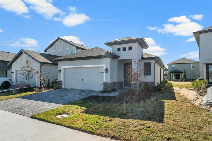 Front exterior of a new home in Reunion Village, Kissimmee, FL, highlighting curb appeal (Image 24).