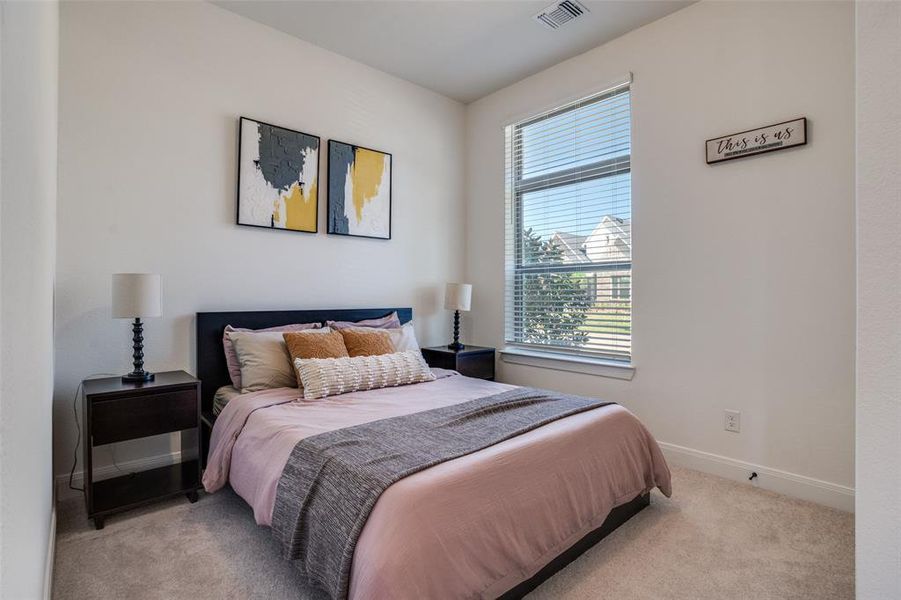 Bedroom featuring baseboards and light colored carpet