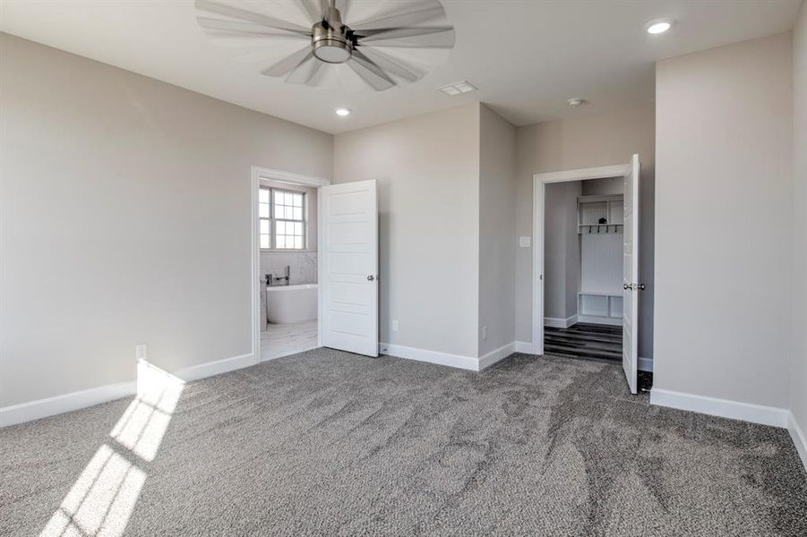 Unfurnished bedroom featuring ensuite bathroom, carpet, ceiling fan, and recessed lighting