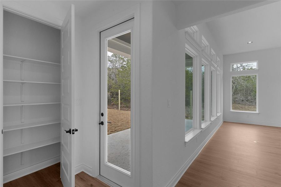 Doorway to outside featuring wood finished floors and recessed lighting
