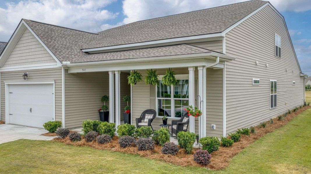 Exterior details and patio area of a home in K. Hovnanian's® Four Seasons at Lakes of Cane Bay, Summerville (Image 3).