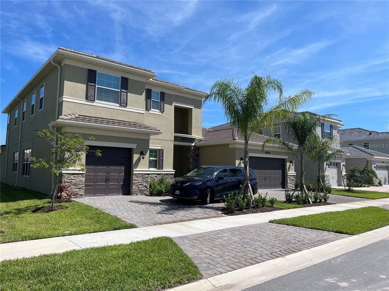 Front exterior of a new home in , Wesley Chapel, FL, highlighting curb appeal (Image 1).