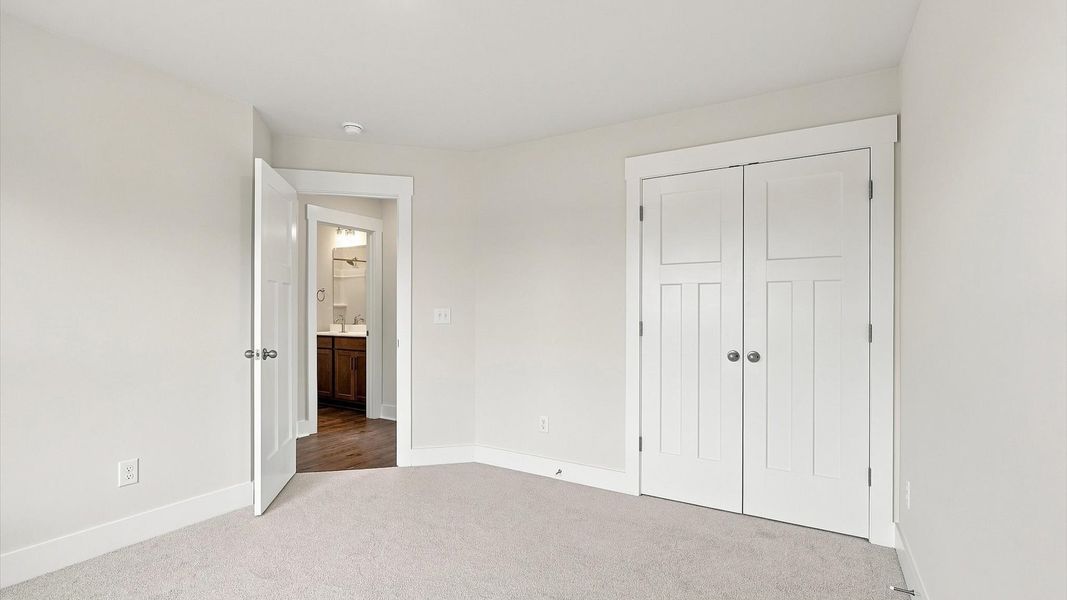 Memorable space with walk-in closet, soft carpeting, and striking natural light from large windows