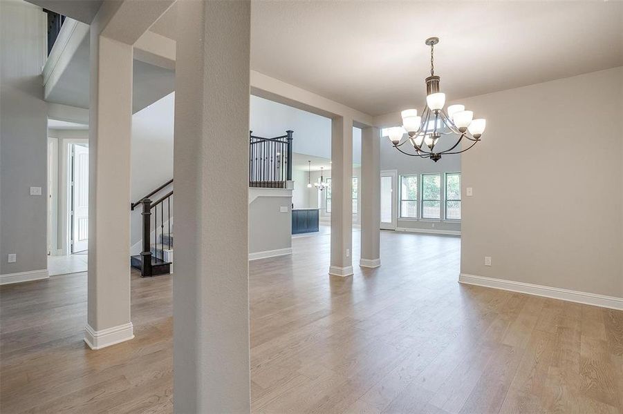 Unfurnished dining area with a chandelier and light hardwood / wood-style flooring