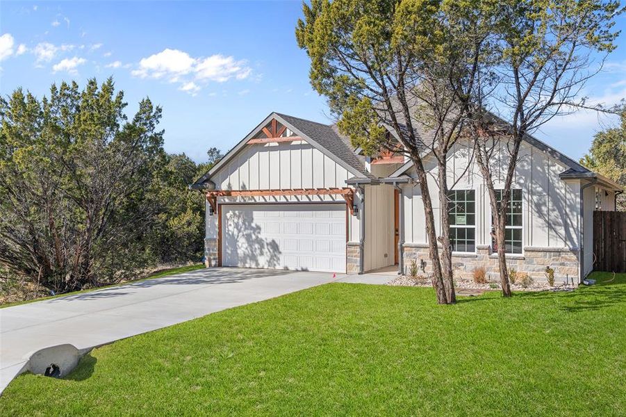 View of front of home featuring a garage and a front lawn