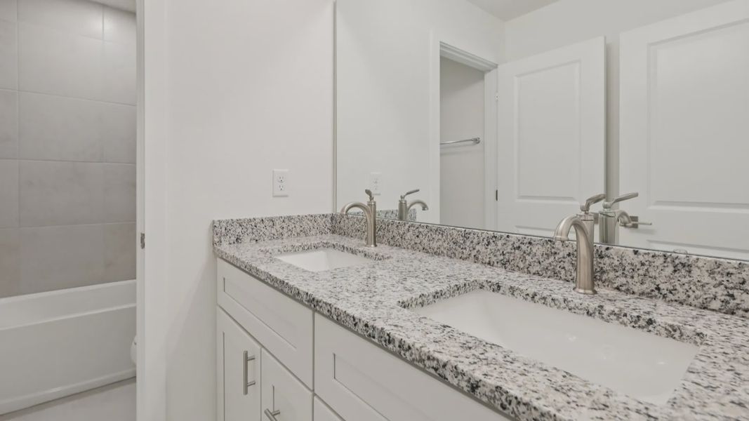 Secondary Bathroom with Dual Sink Vanity in the Naples Floor Plan by DRB Homes Secondary Bathroom with Dual Sink Vanity in the Naples Floor Plan by DRB Homes