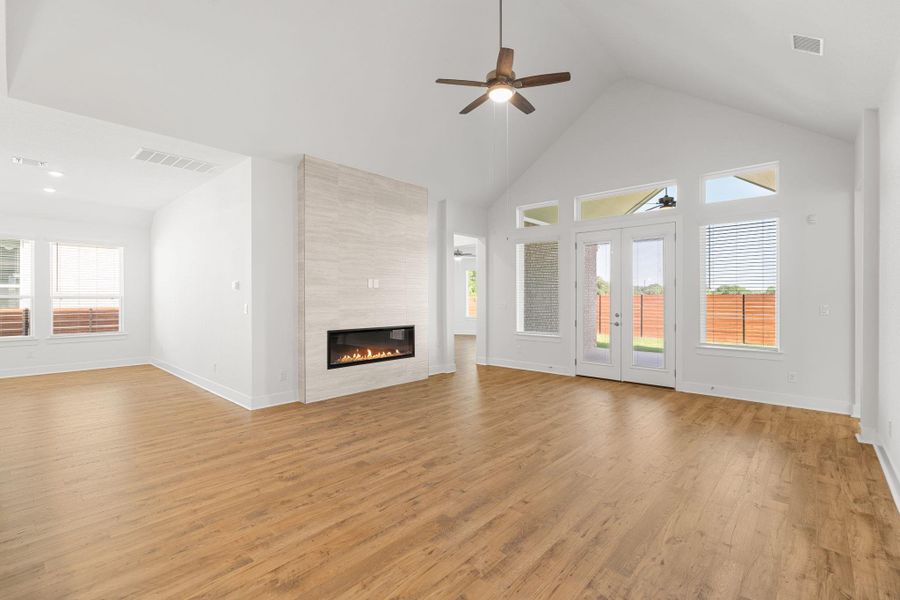 A spacious living area with vaulted ceilings and a modern fireplace offers comfort and style.