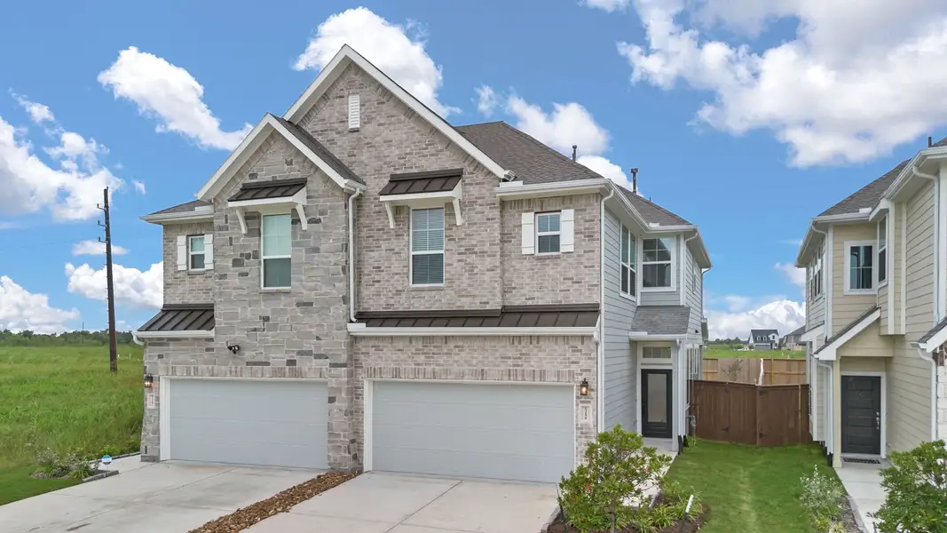 Front exterior of a new home in Meridiana, Manvel, TX, highlighting curb appeal (Image 18).