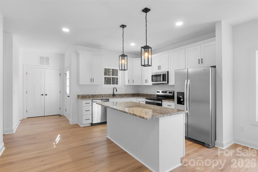 Kitchen with granite countertops, shaker cabinets and stainless steel appliances Kitchen with granite countertops, shaker cabinets and stainless steel appliances