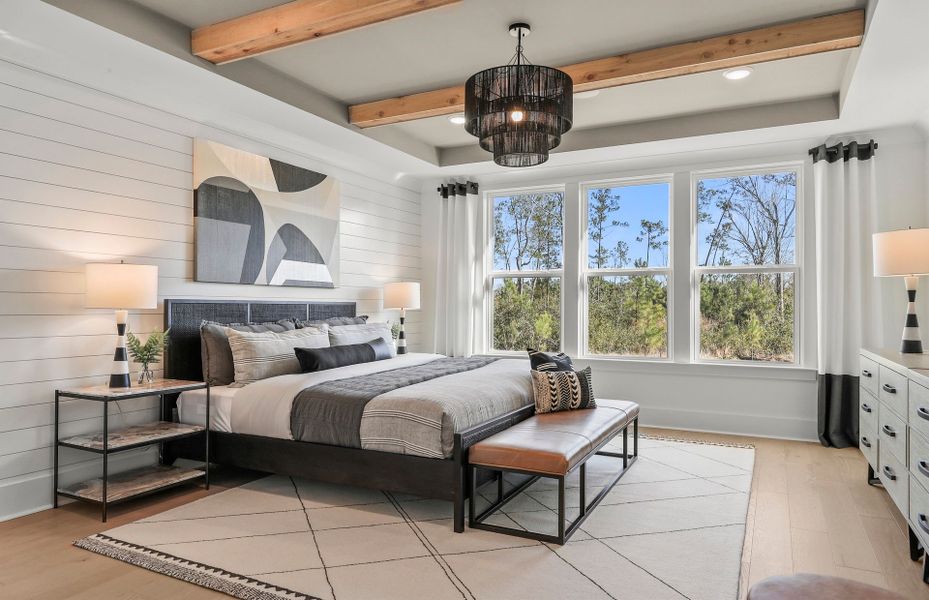 The owner's suite features impressive wood-crafted ceiling beams, infusing the space with rustic charm.