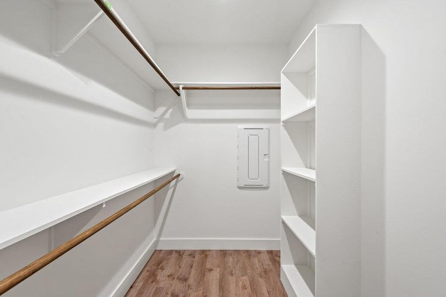 Spacious closet featuring light wood-style floors and electric panel
