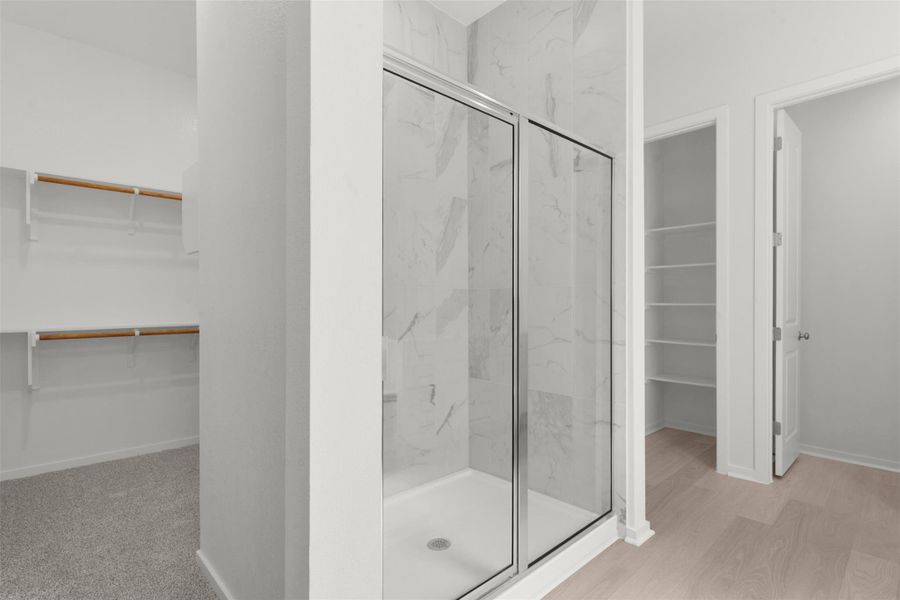 Bathroom with a *PHOTO REPRESENTATIVE OF FLOORPLAN ONLY*closet, a marble finish shower, and light wood-type flooring Bathroom with a *PHOTO REPRESENTATIVE OF FLOORPLAN ONLY*closet, a marble finish shower, and light wood-type flooring