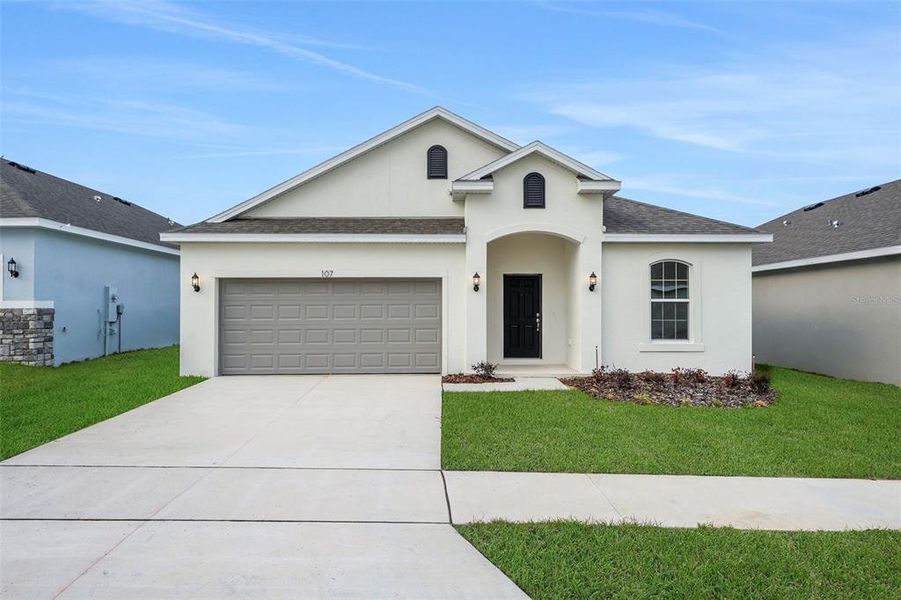 Front exterior of a new home in Cypress Park Estates, Haines City, FL, highlighting curb appeal (Image 20).