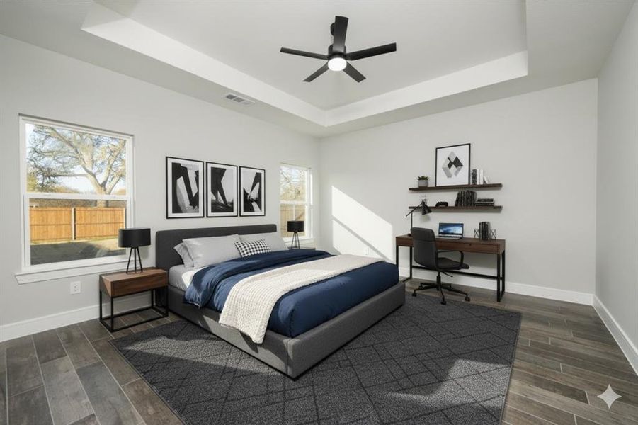 Bedroom with wood tiled floors, an office area, a tray ceiling, and a ceiling fan